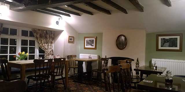 The Triangle Inn has an intimate dining room with a bay window providing views over the park to the River Wye